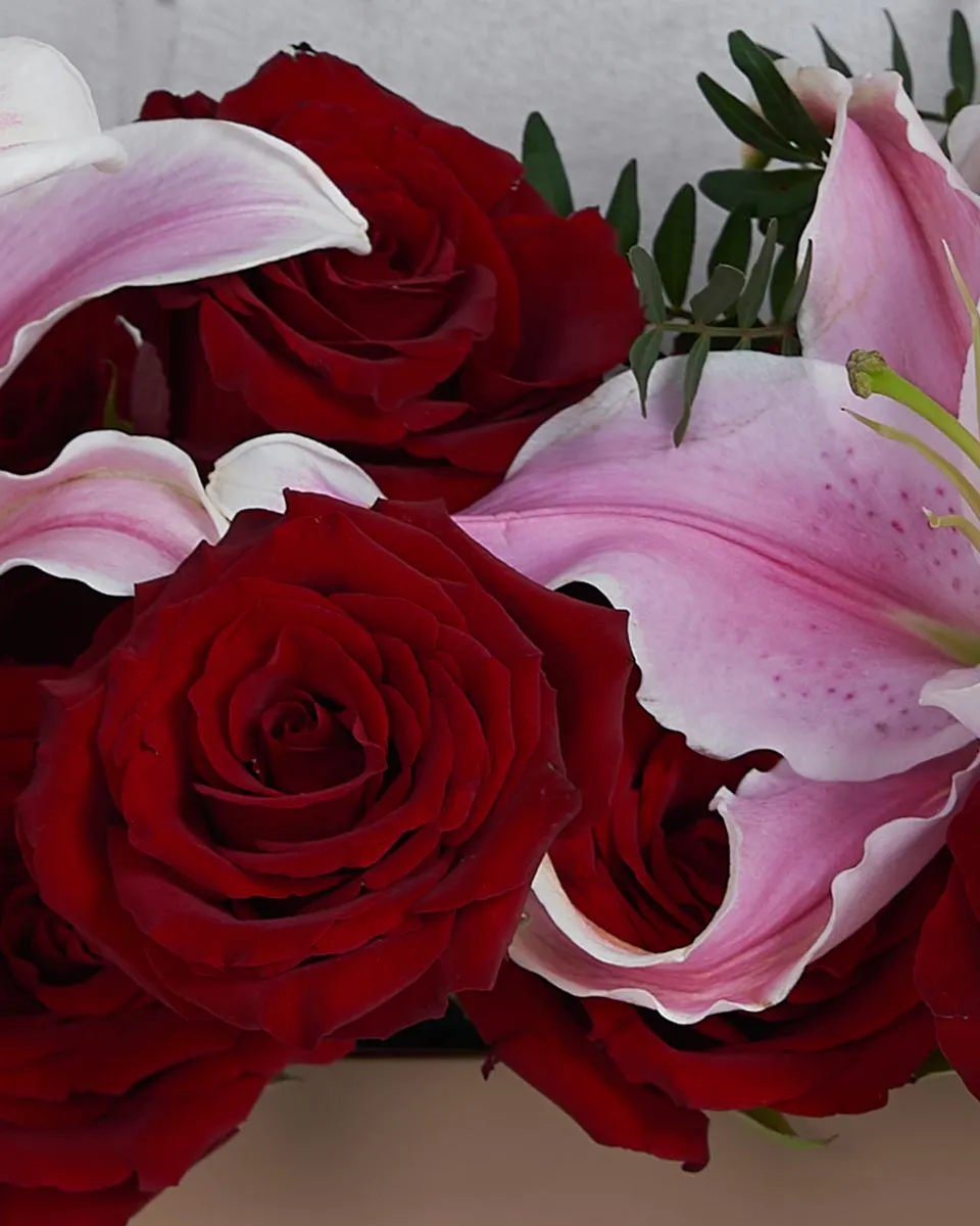 As Lovely As You   Toolbox Combination of Pink Lily and rose red with touch of pistacia 4 lilys  12 red rose .5 pistacia Details